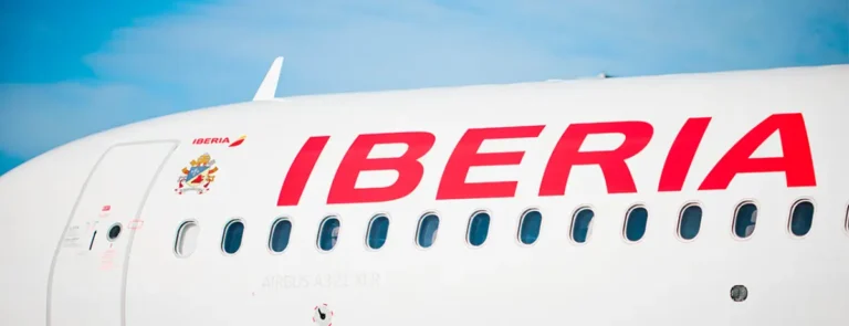 Close-up of an Iberia Airbus A321XLR aircraft fuselage with airline branding at the airport