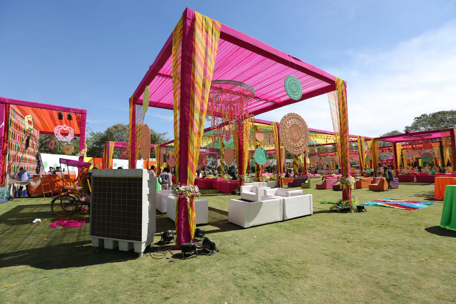 Thailand Risks Losing 8 Billion Baht As Visa Change Threatens Indian Wedding Tourism 3 Colorful outdoor Indian wedding venue decorated with pink and yellow fabric canopies, hanging ornaments, and vibrant seating arrangements on a lawn