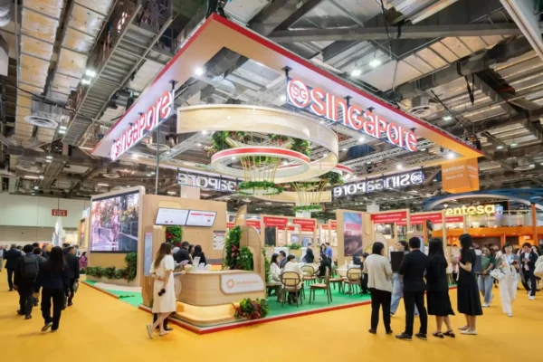 Home 2 Singapore tourism pavilion at a major travel trade exhibition with visitors and exhibitors networking at ITB Asia