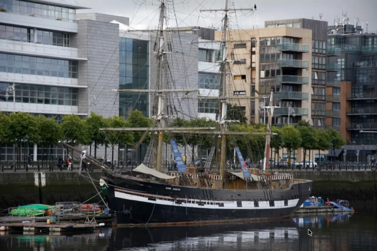 The Most Atmospheric Walks In Dublin For First-Time Visitors 4 The Jeanie Johnston replica tall ship moored on the Liffey at Custom House Quay against modern Dublin Docklands buildings