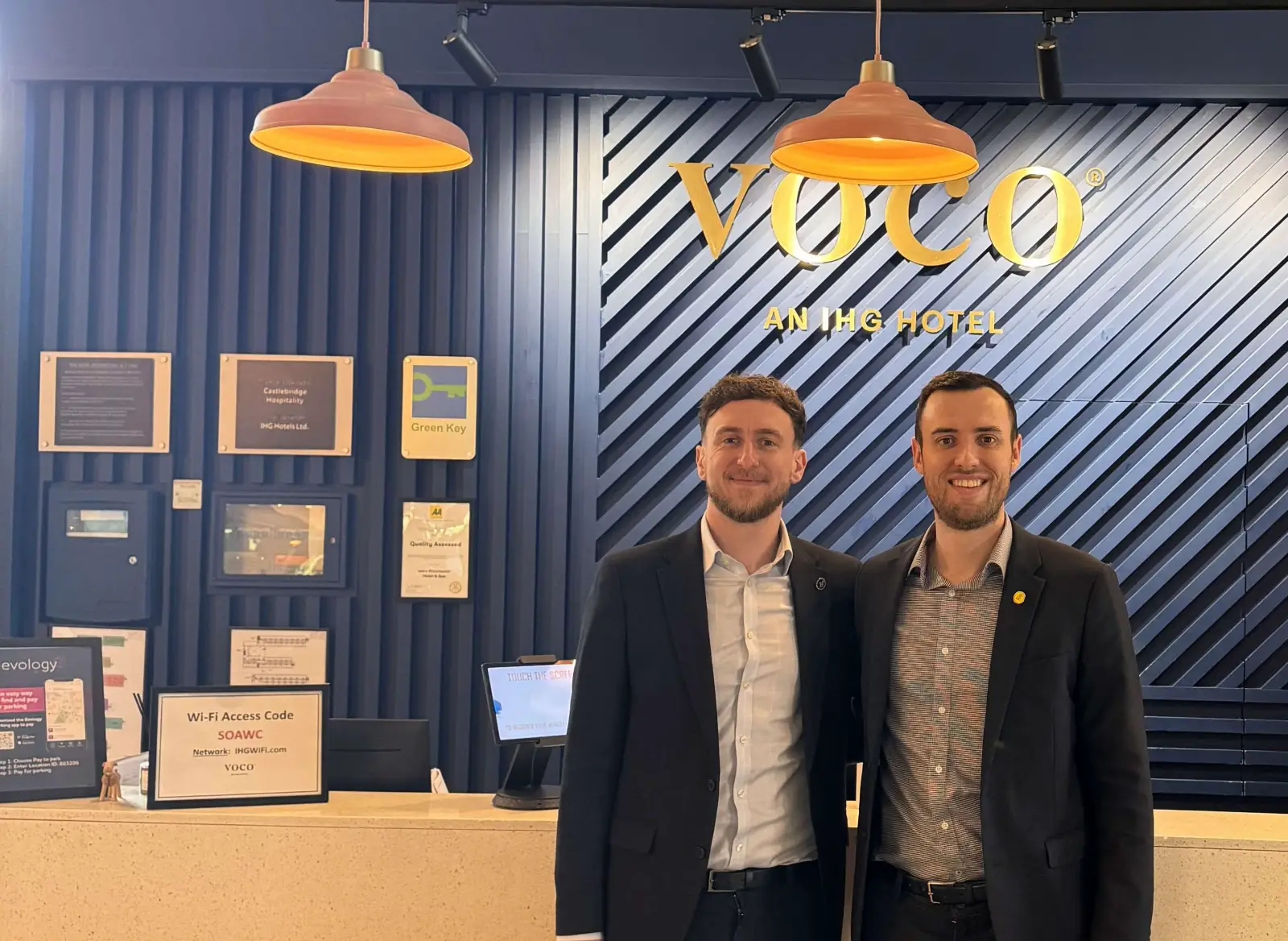 Joe Davidovitz and James Watson standing at the reception desk of voco Winchester Hotel & Spa following their leadership appointments.