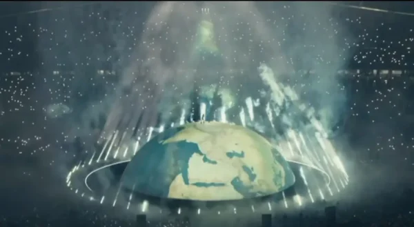 A giant globe-shaped stage at Ataturk Olympic Stadium in Istanbul on 30 May 2026, with the silhouette of Kanye West standing at its peak surrounded by laser beams, smoke effects and the lights of 118,000 fans filling the stadium
