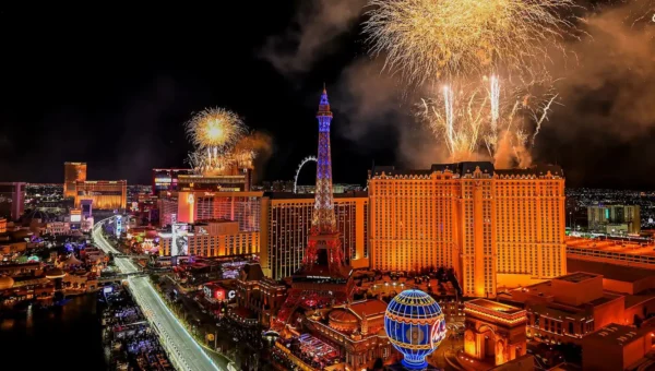 Fireworks light up the Las Vegas Strip at night above the Eiffel Tower replica and casinos, with the F1 circuit running through the heart of the destination