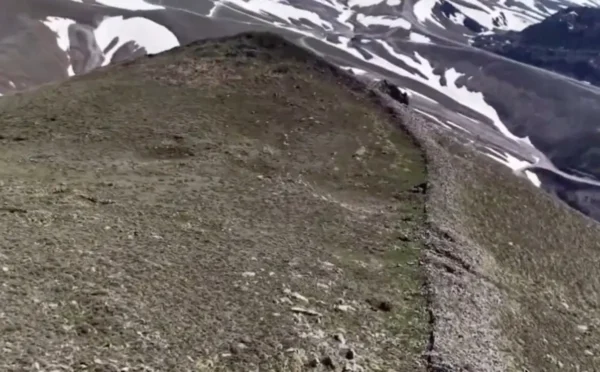 Drone view of ancient dry-stone walls emerging from the snow-free slopes of Lifos Mountain in Kayseri, Turkey