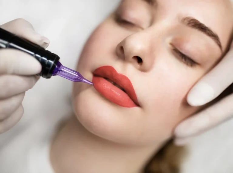 ALT Text: Close-up of a woman receiving a semi-permanent lip blush cosmetic treatment with a pigmentation device.