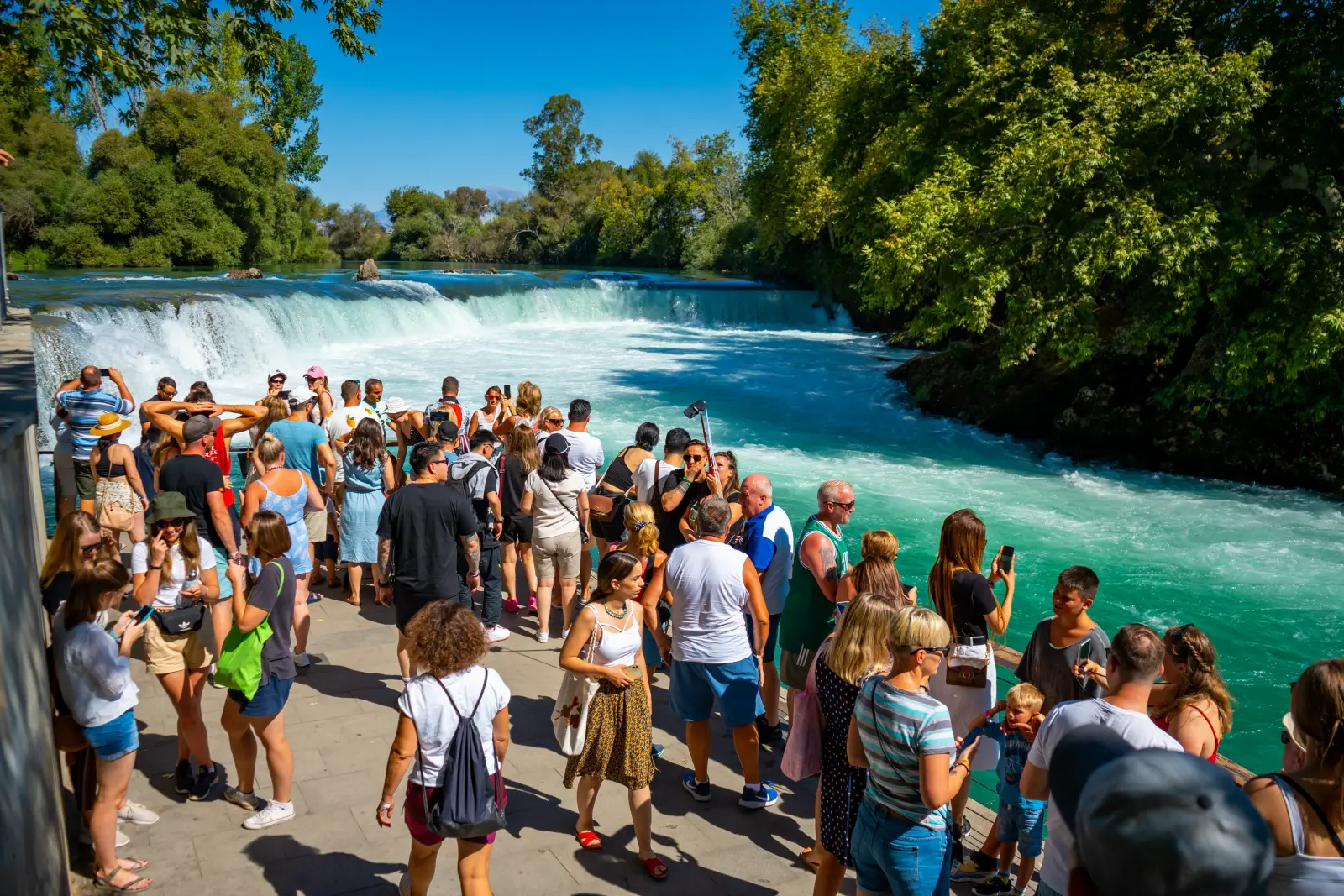 Visitors gather at the viewing platform overlooking Manavgat Waterfall, one of Türkiye's most popular natural attractions near Antalya.