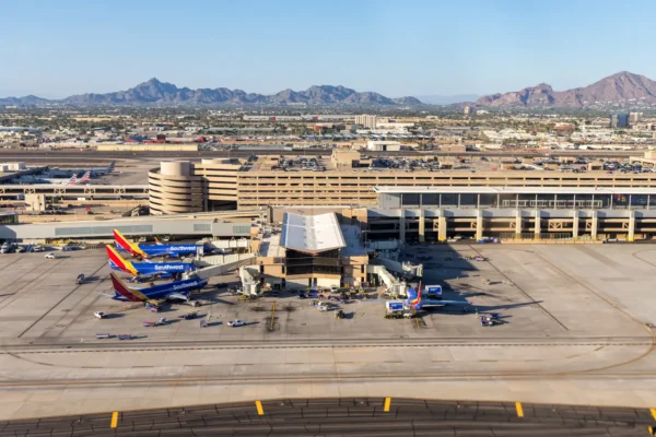 Aerial view of Southwest Airlines Boeing 737 aircraft parked at Phoenix Sky Harbor International Airport with desert mountains in the background