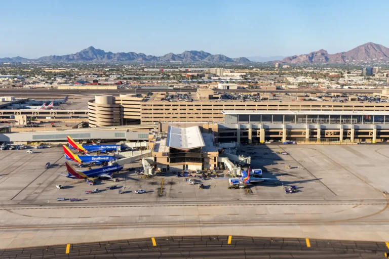 Aerial view of Southwest Airlines Boeing 737 aircraft parked at Phoenix Sky Harbor International Airport with desert mountains in the background