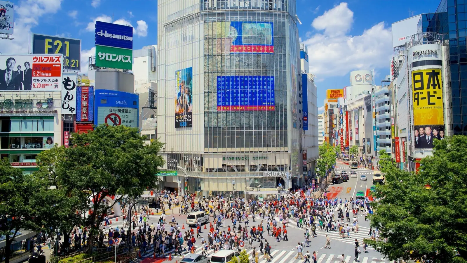Tokyo’s Shibuya Introduces On-The-Spot Fines For Littering Amid Overtourism 3 Crowds of pedestrians cross the famous Shibuya Crossing in Tokyo, surrounded by large digital billboards, shops and commercial buildings.