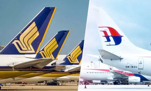 Aircraft tails of Singapore Airlines and Malaysia Airlines parked at an airport, illustrating the carriers' expanded partnership and joint fare products.
