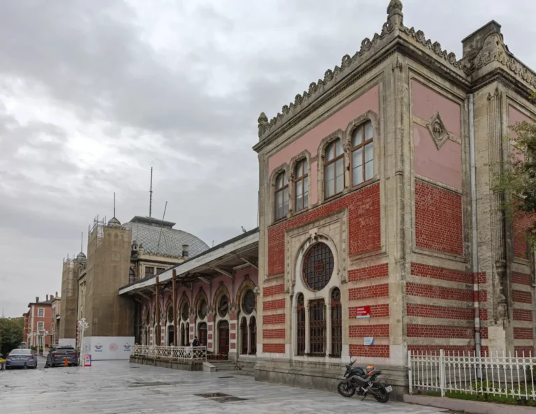Historic Sirkeci Terminal railway station in Istanbul with red-brick facade and overcast sky