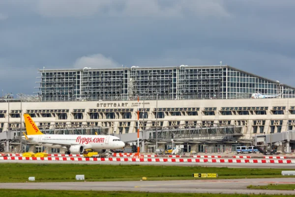 Pegasus Airlines aircraft parked on the apron in front of Stuttgart Airport terminal in Germany.