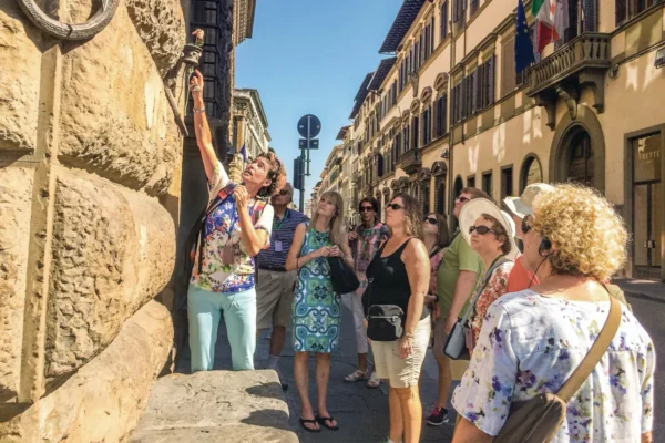 Women travellers join a guided walking tour through the historic streets of Florence, Italy, during a small group cultural experience