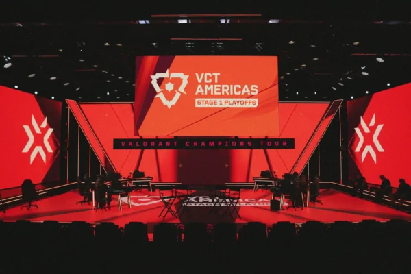 Large esports arena stage hosting the Valorant Champions Tour Americas playoffs with giant digital screens and gaming setup.