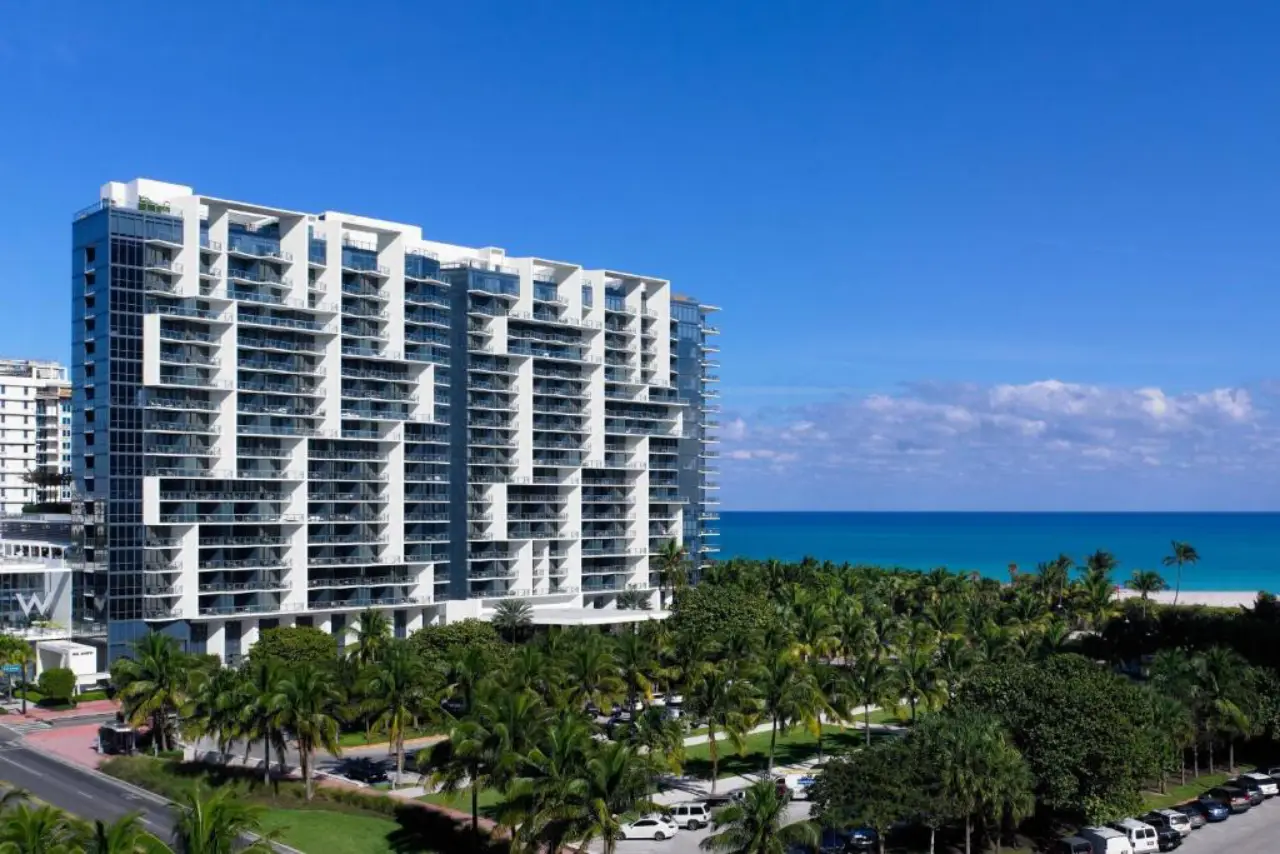 Aerial view of W South Beach hotel tower with palm trees and the Miami Beach oceanfront