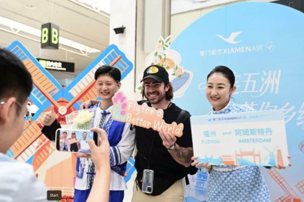 XiamenAir celebrates the launch of its Fuzhou to Amsterdam route as cabin crew welcome passengers during the inaugural flight event at the airport.