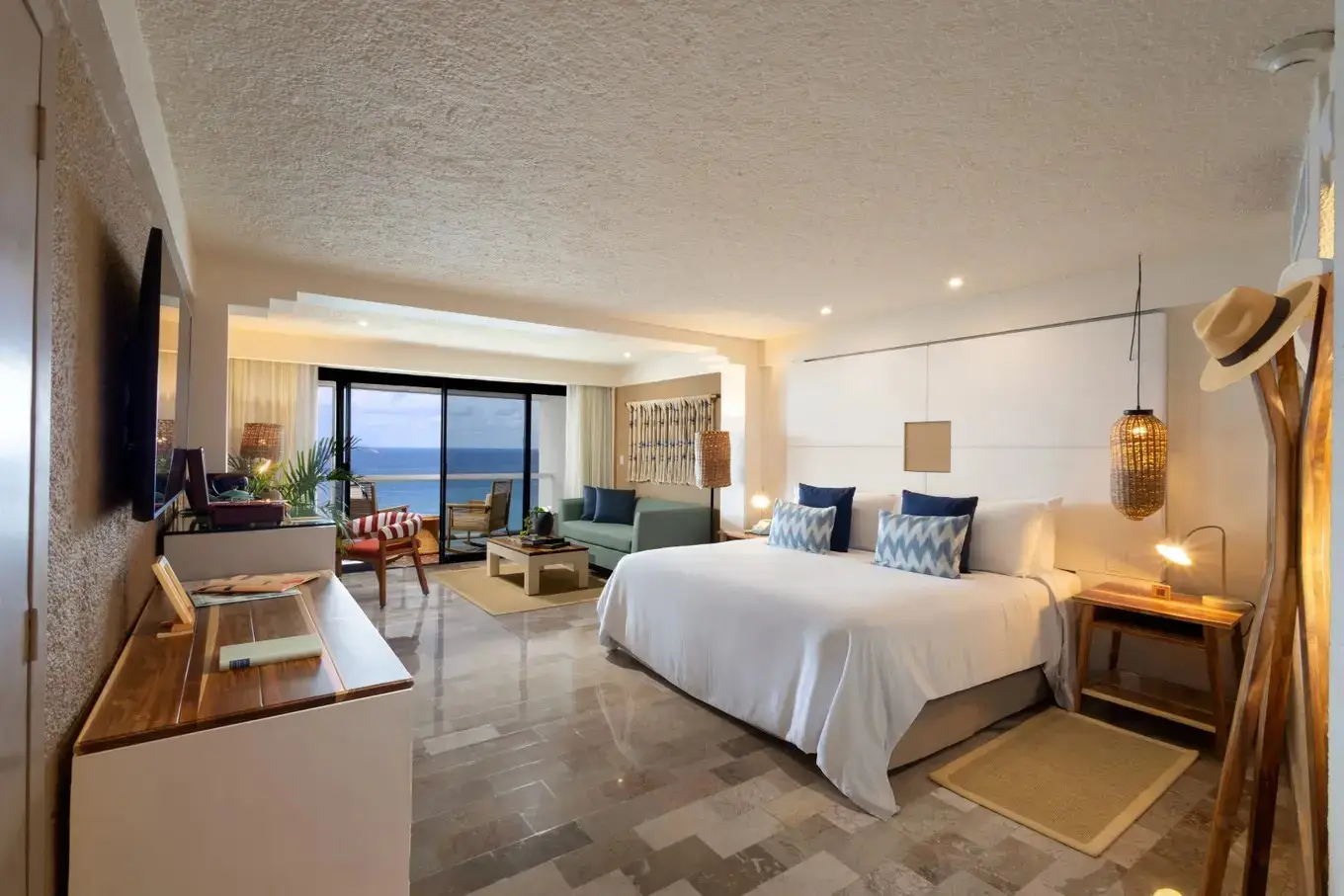 Meliá Hotels And Rafael Nadal Expand Zel Hotels To Mexico With The Opening Of Zel Cozumel In Fall 2026 3 Ocean view suite at ZEL Cozumel with king bed, blue accent pillows, seating area and Caribbean sea views