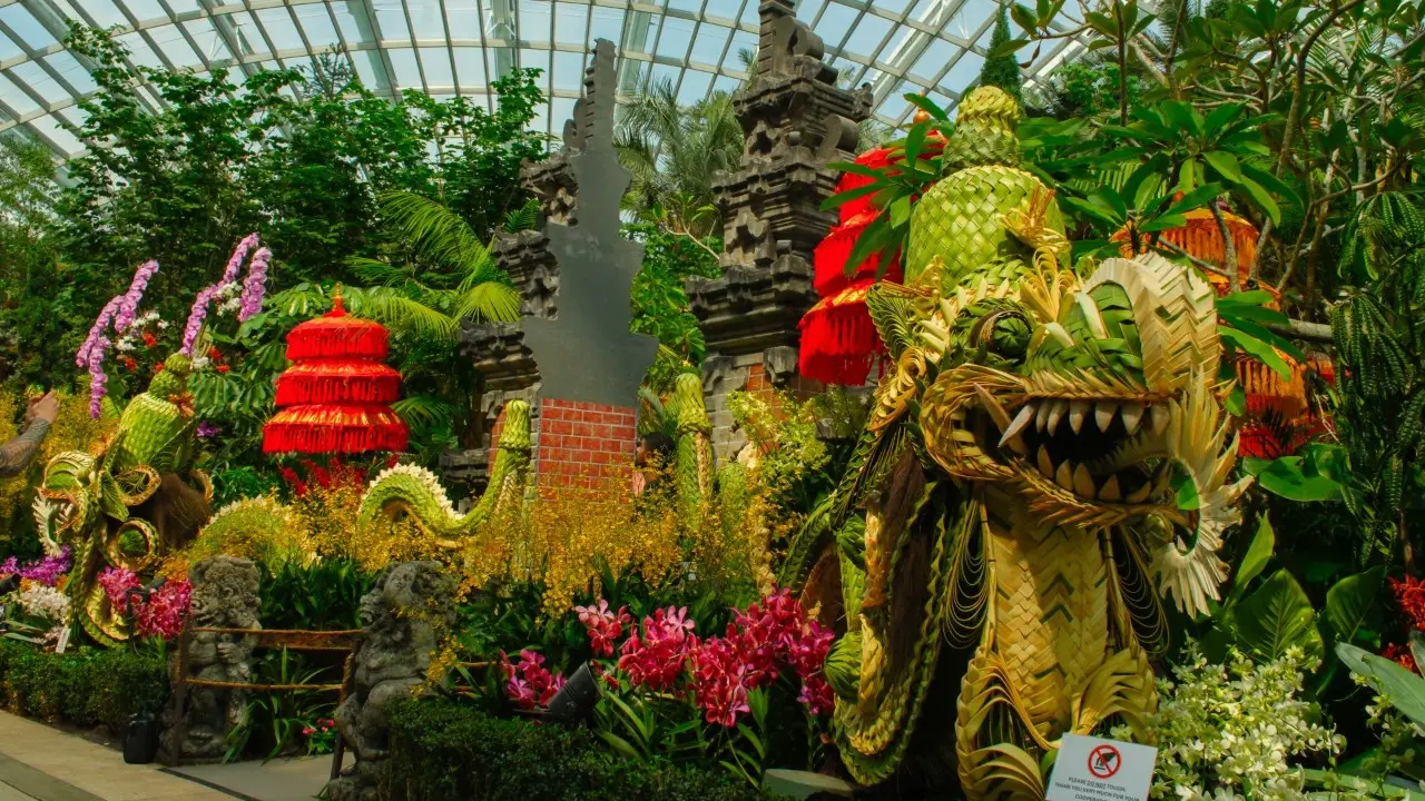 Handwoven naga dragon sculpture surrounded by orchids at Gardens by the Bay display