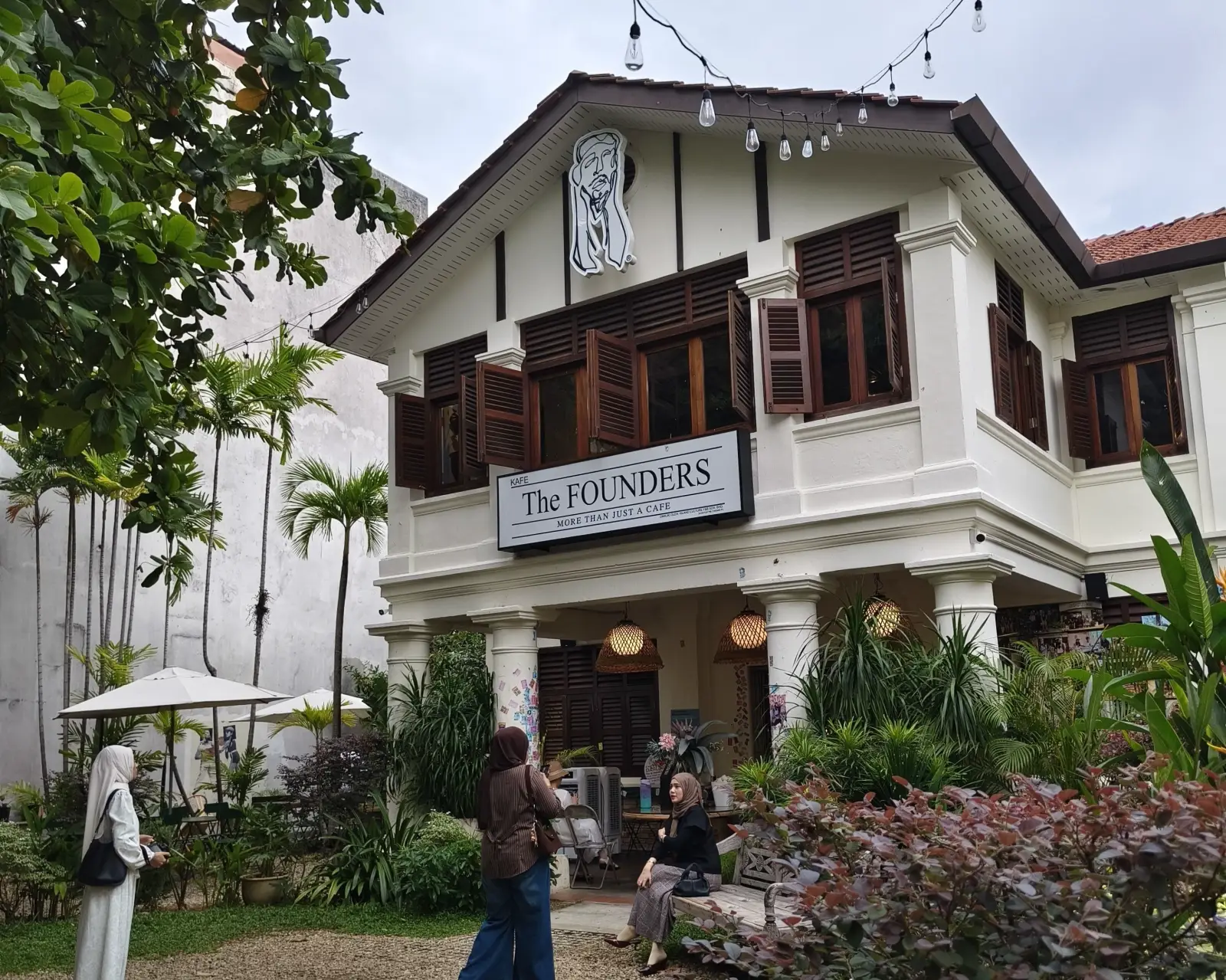 The Founders café occupies a restored heritage building surrounded by tropical gardens in Penang.