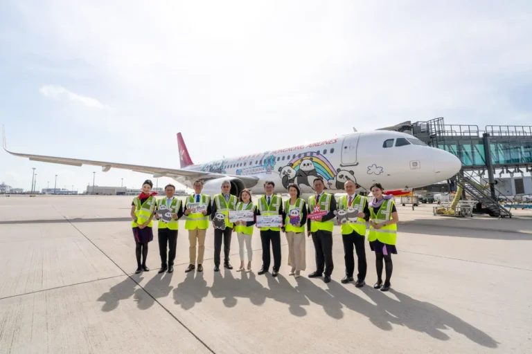 Hong Kong Airlines celebrates the launch of its Panda Friends themed aircraft with airline and Ocean Park representatives standing in front of the special livery at Hong Kong International Airport.