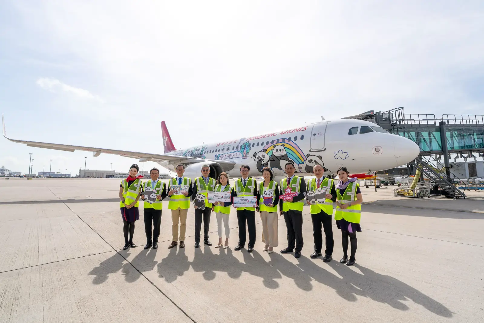 Hong Kong Airlines Unveils New Interiors And Collectibles For Panda Friends Livery Aircraft 3 Hong Kong Airlines celebrates the launch of its Panda Friends themed aircraft with airline and Ocean Park representatives standing in front of the special livery at Hong Kong International Airport.
