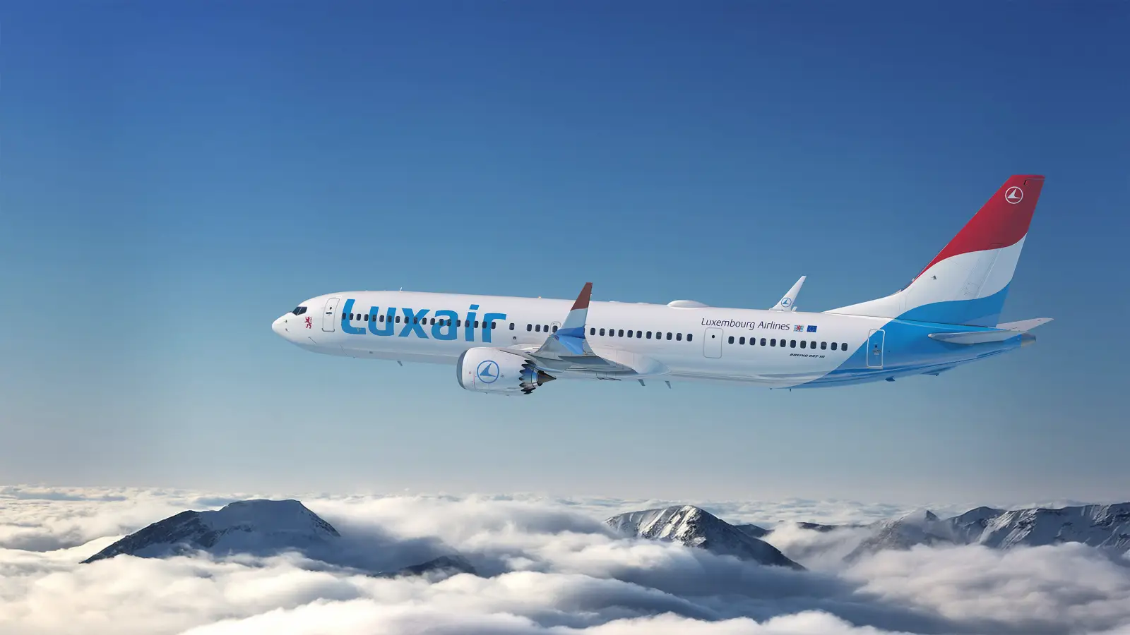 Luxair Firms Up Order For More Boeing 737-10 Jets 5 A Luxair Boeing 737-10 aircraft in Luxembourg Airlines livery flying above clouds and mountain peaks against a clear blue sky