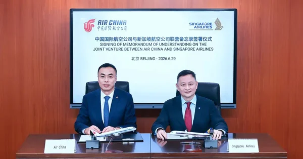 Air China and Singapore Airlines executives sign a memorandum of understanding for a commercial joint venture partnership in Beijing.