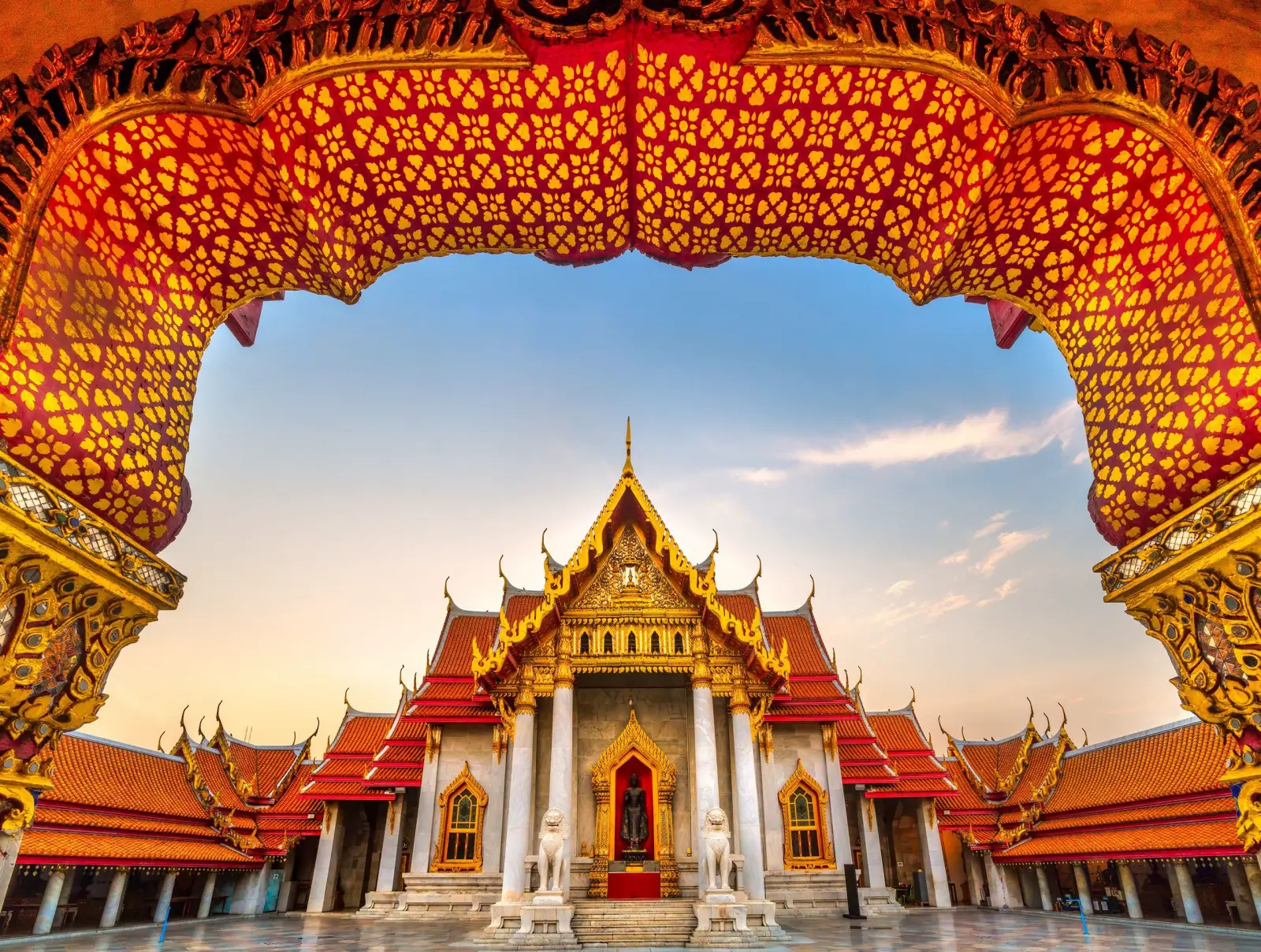 Flydubai Doubles Daily Flights To Bangkok Amid Strong Travel Demand 7 Wat Benchamabophit, the Marble Temple in Bangkok, framed by an ornate Thai temple arch at sunset.
