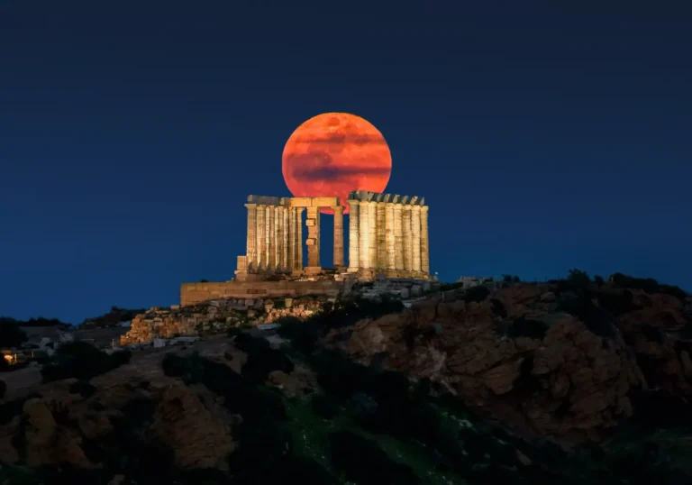 Tours 21 Blood Moon rising behind the ancient Temple of Poseidon at Cape Sounion in Attica, Greece.