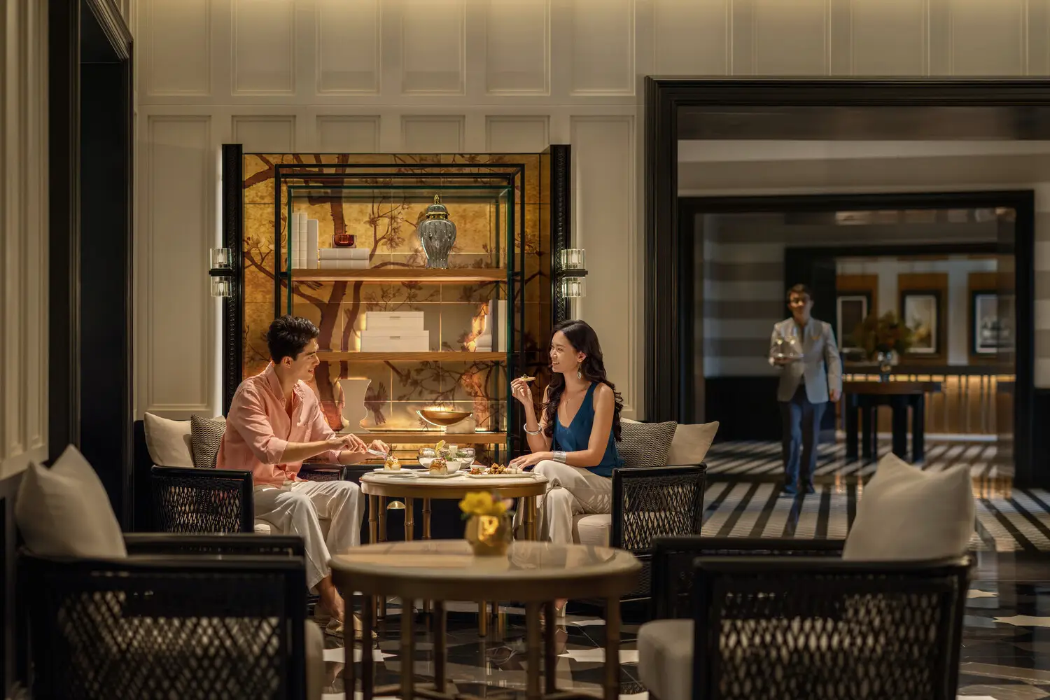 Beyond The Gen Z Myth: Four Distinct Luxury Mindsets Reshaping Travel In Asia Pacific 3 Affluent travelers enjoy afternoon tea in a luxury hotel lounge, reflecting the Connoisseur Traditionalist travel mindset focused on premium service and refined hospitality.