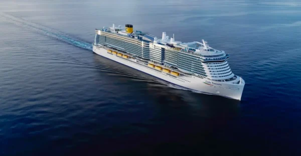 Home 6 Aerial view of the Costa Toscana cruise ship sailing across calm open sea under clear skies.