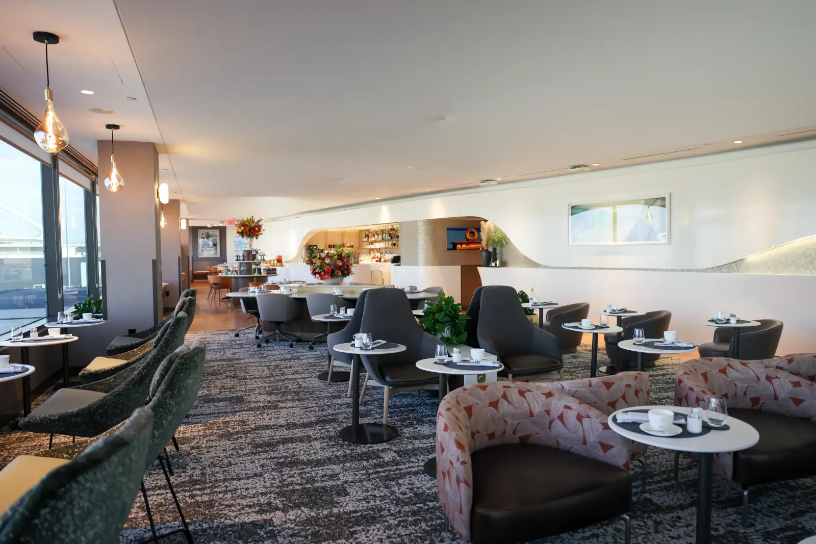 Interior of the Delta One Lounge at Los Angeles International Airport with modern seating and dining areas.