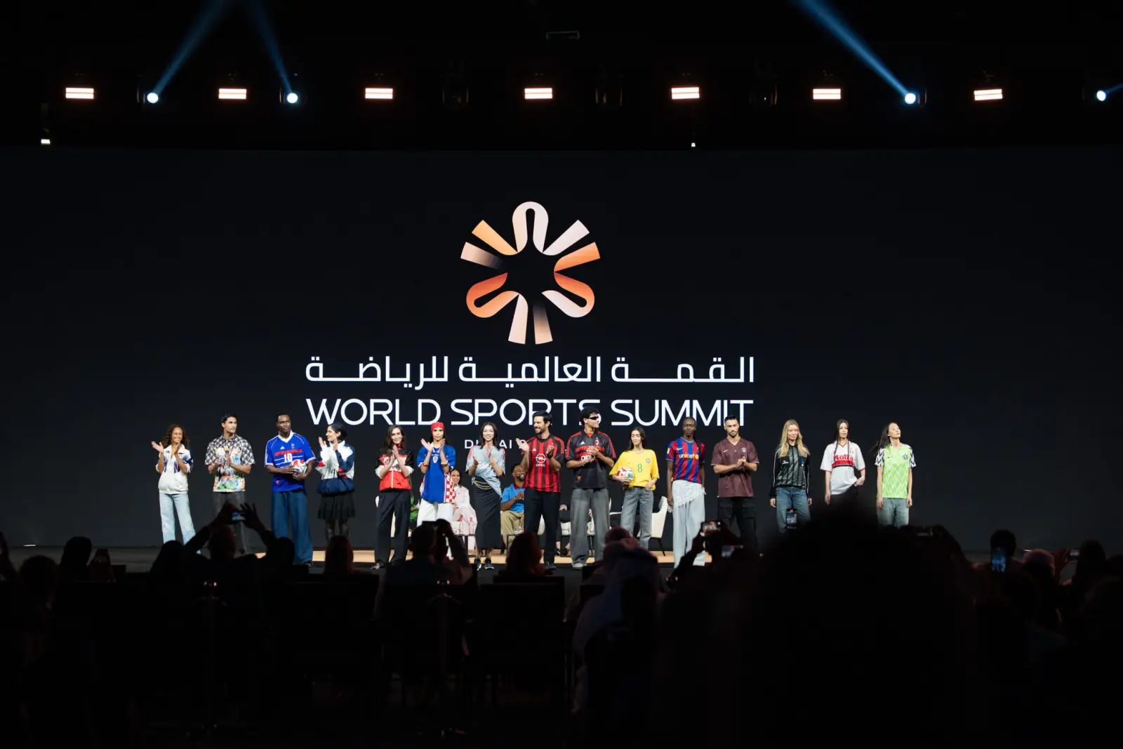 Dubai To Host World Sports Summit 2026 4 Speakers and athletes on stage during the World Sports Summit in Dubai with the event logo displayed on a large screen.