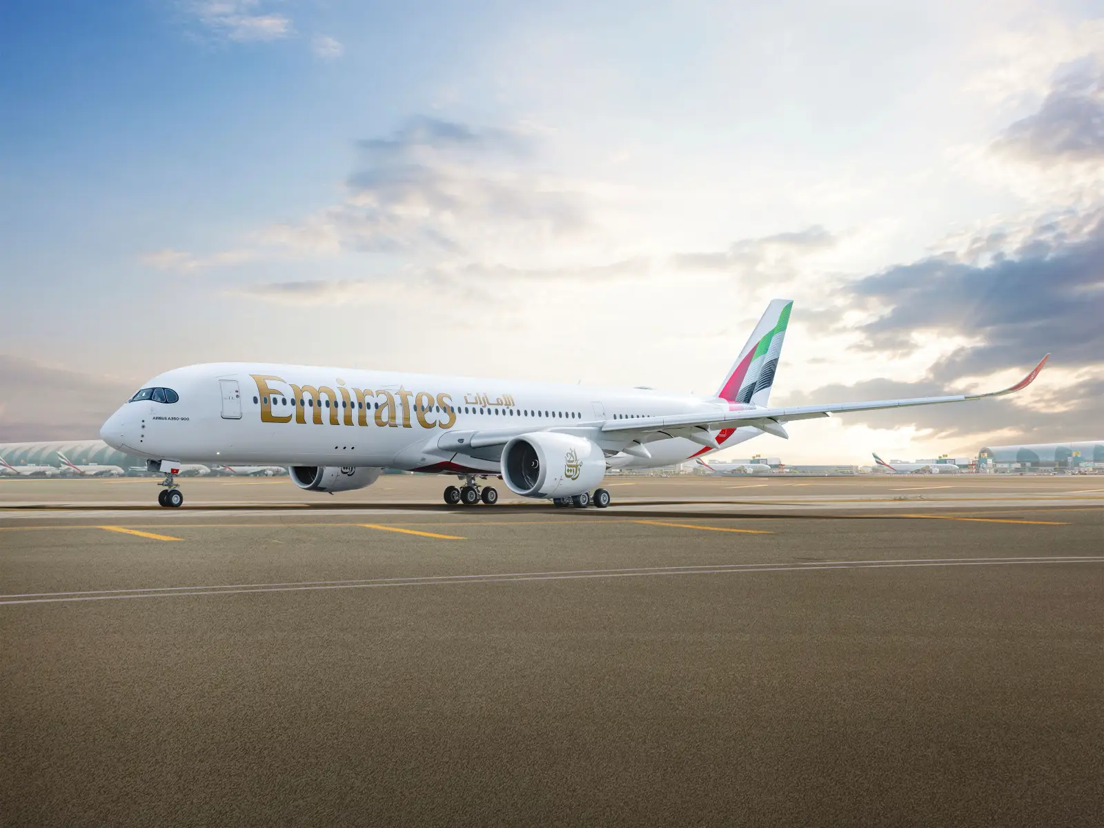 Emirates Airbus A350-900 aircraft on the taxiway at Dubai International Airport before departure.