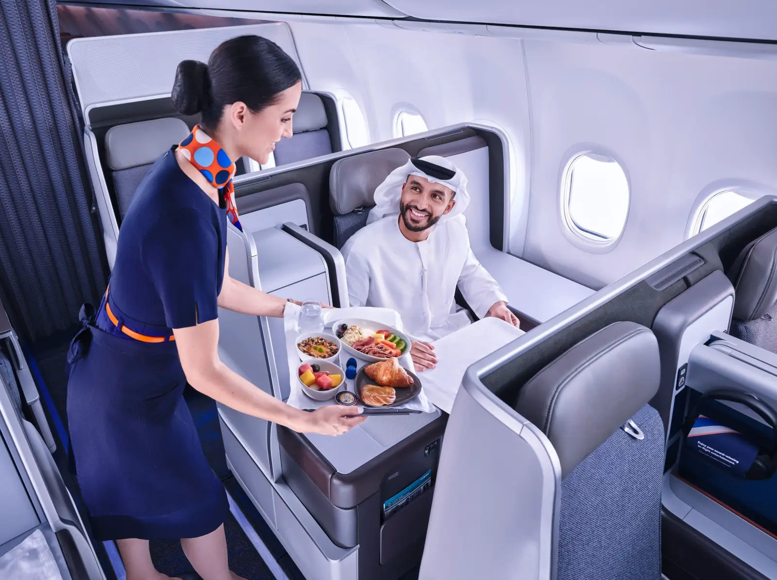 Flydubai Doubles Daily Flights To Bangkok Amid Strong Travel Demand 3 A flydubai cabin crew member serves a meal to a passenger seated in the airline's Business Class cabin on board a Boeing 737 aircraft.