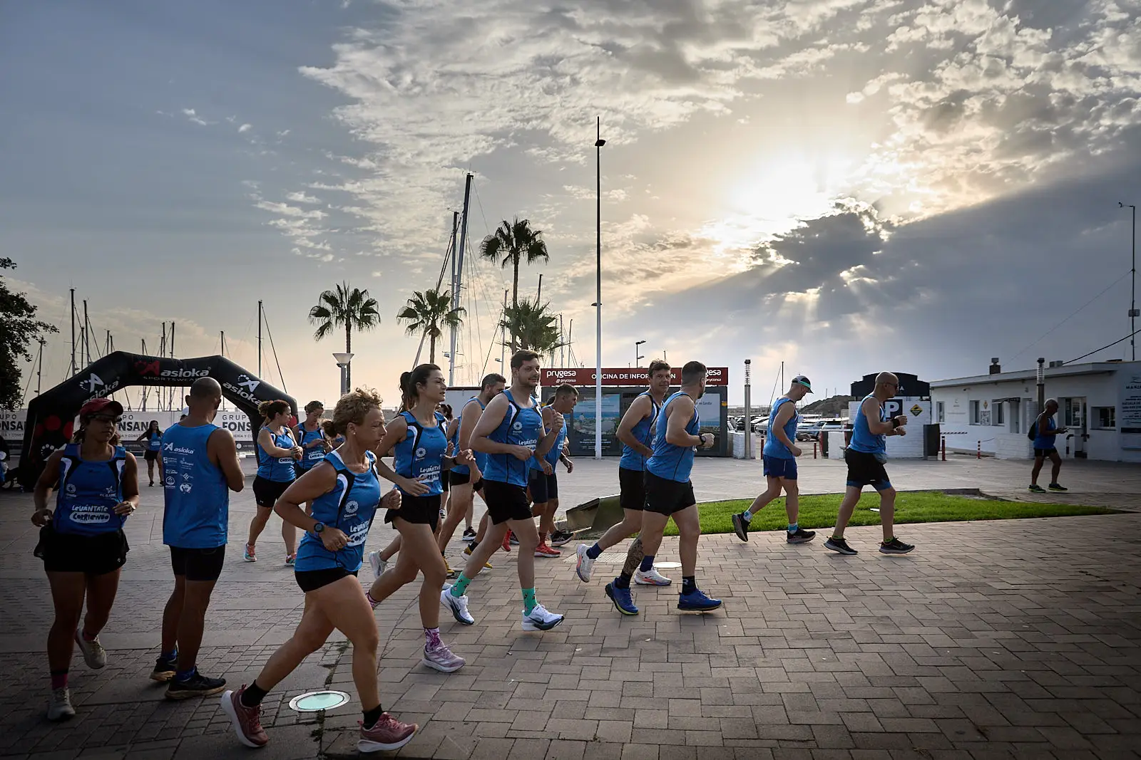Participants take part in the Levantate Corriendo running event along the Gandia waterfront in Spain