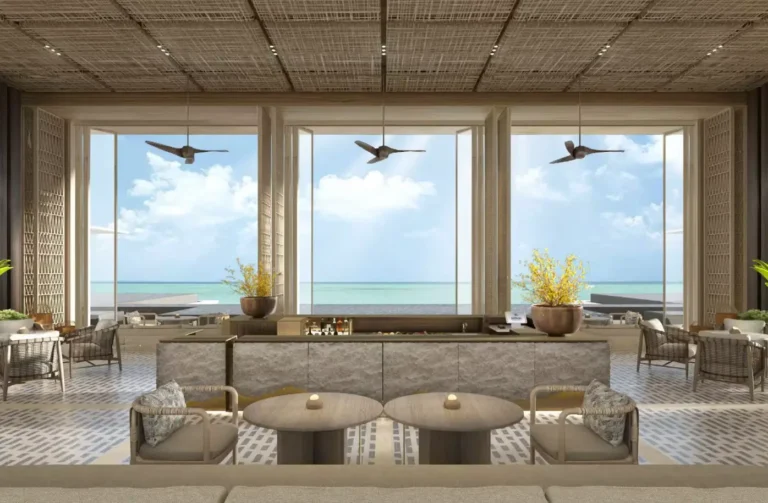 Lobby lounge at Hilton Burau Bay Langkawi Resort overlooking the Andaman Sea through floor-to-ceiling windows with contemporary tropical design.