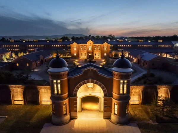 Home 17 Aerial twilight view of HOSHINOYA Nara Prison, a restored Meiji-era prison transformed into a luxury heritage hotel in Nara, Japan.