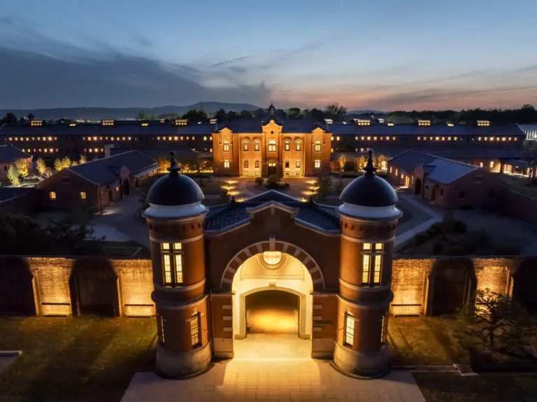 Aerial twilight view of HOSHINOYA Nara Prison, a restored Meiji-era prison transformed into a luxury heritage hotel in Nara, Japan.