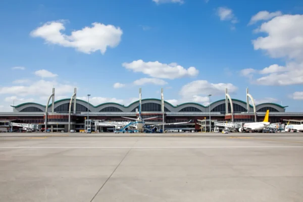 Home 8 Exterior view of Istanbul Sabiha Gökçen International Airport terminal with parked aircraft