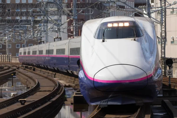 Home 3 A JR Shinkansen bullet train travels along the Tokyo–Osaka railway line through an urban area in Japan.