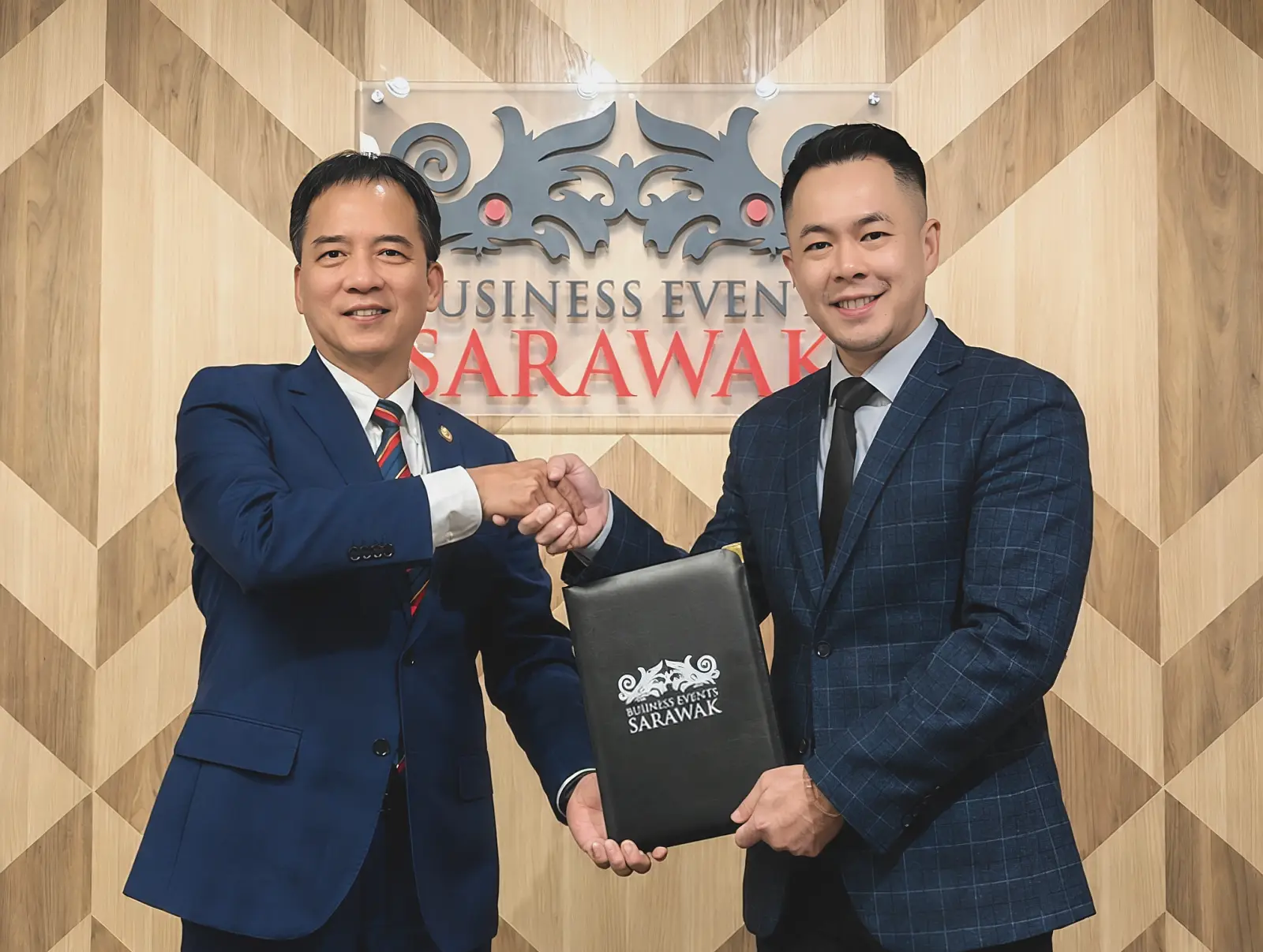 Datu Hii Chang Kee presents Jason Tan Chin Foo with his official appointment as CEO of Business Events Sarawak.