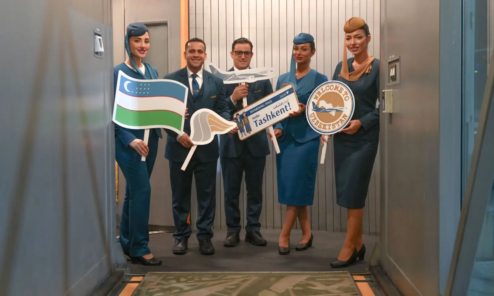 Oman Air Launches Direct Services To Singapore And Tashkent 4 Oman Air crew celebrate the launch of direct flights between Muscat and Tashkent with Uzbekistan-themed welcome signs.