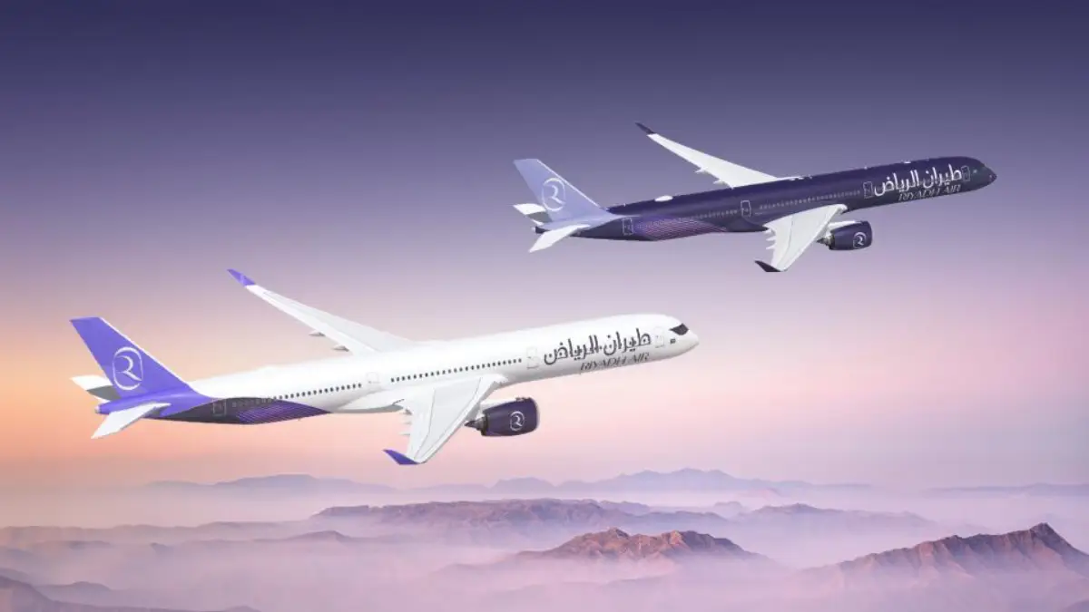 Riyadh Air Orders Six More Airbus A350-1000S 5 Two Riyadh Air Airbus A350-1000 aircraft in the airline's white and purple liveries fly over a mountain landscape at sunset.