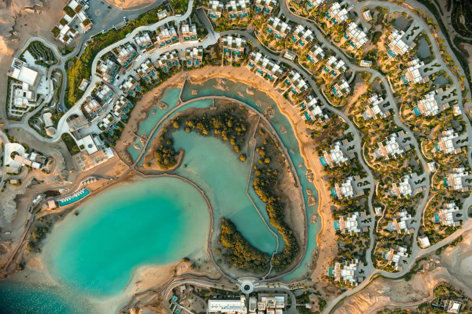 Aerial view of Six Senses AMAALA resort villas surrounding a mangrove lagoon