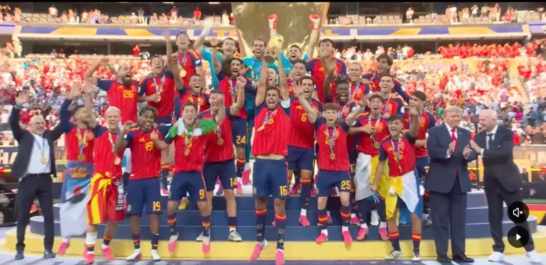 Home 13 Spain's players celebrate with the FIFA World Cup trophy after defeating Argentina in the 2026 World Cup final.