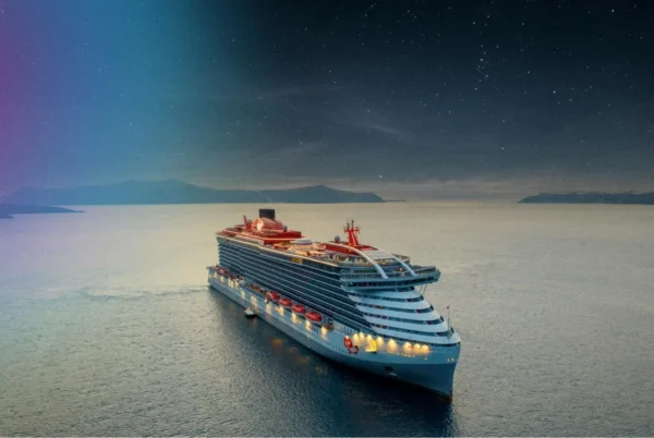 Home 6 Virgin Voyages' Scarlet Lady sails beneath a star-filled sky, highlighting the cruise line's solar eclipse voyages in 2026 and 2027.