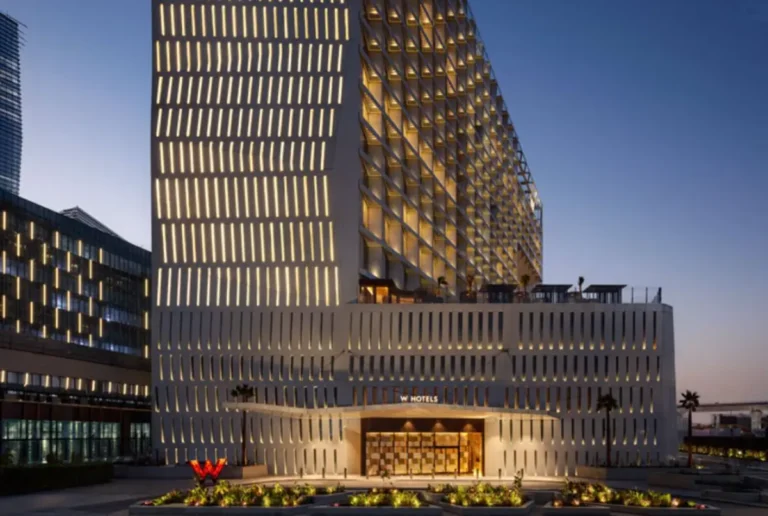 Accommodation 11 Exterior view of W Riyadh KAFD hotel in King Abdullah Financial District illuminated at dusk.