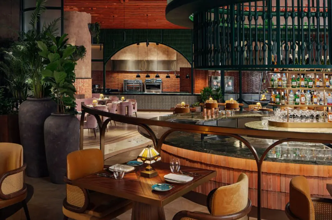 W Hotels Makes Its Debut In Saudi Arabia With The Opening Of W Riyadh 5 Dining area at W Riyadh KAFD showcasing an open kitchen, stylish seating and contemporary restaurant design.